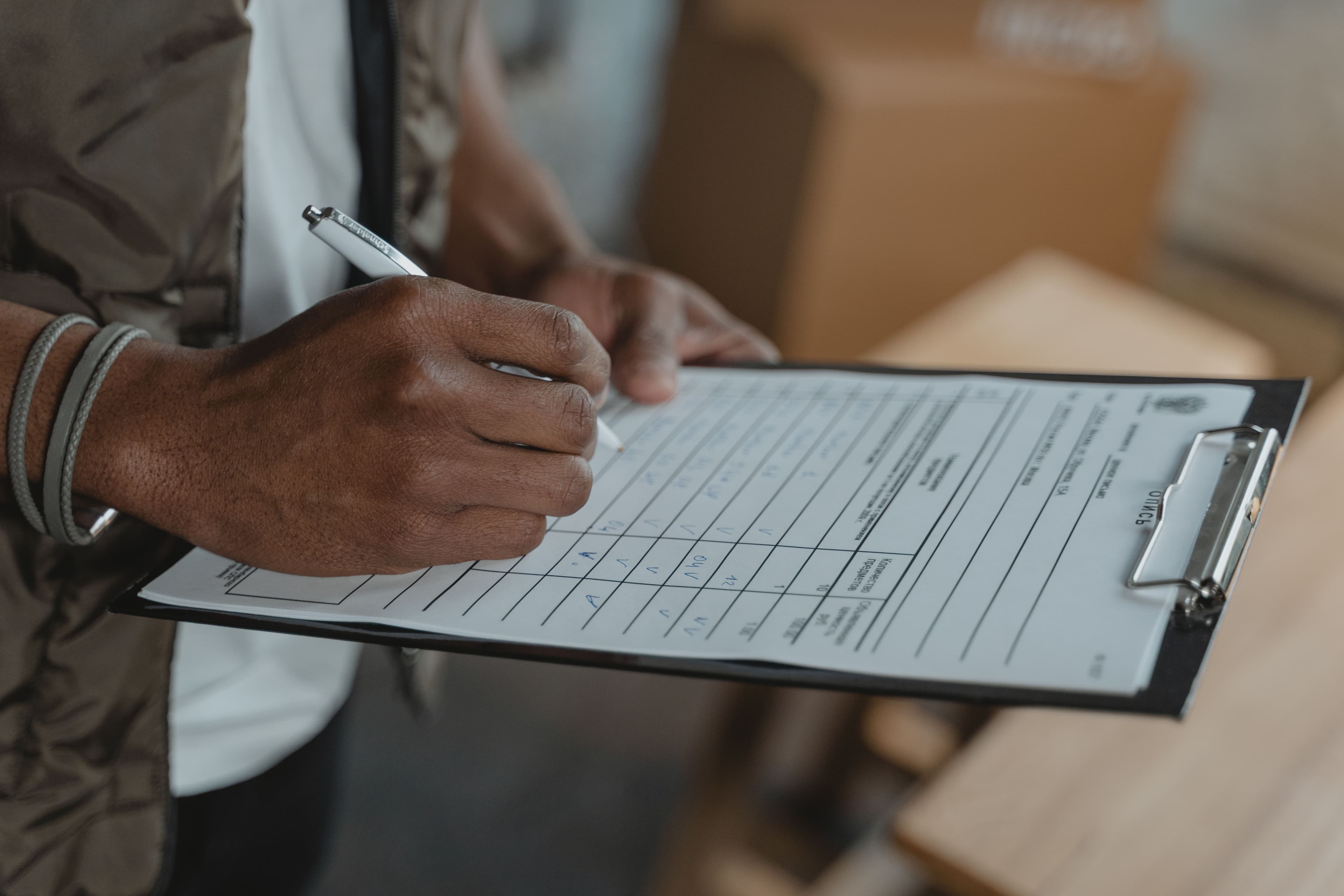 Technician completing a checklist on a clipboard.