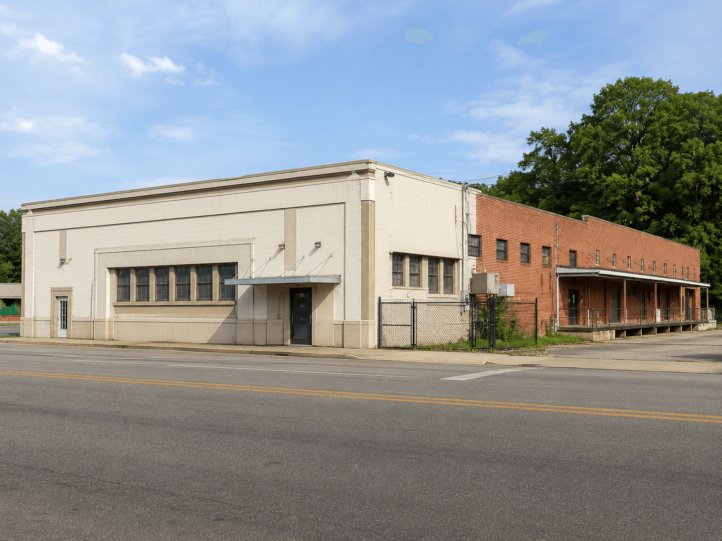 Large commercial warehouse exterior viewed during a property visit.